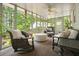 Comfortable sunroom with large windows offering scenic views and relaxing seating at 627 Apache Trl, Woodstock, GA 30189