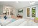 Inviting sunroom connecting to the kitchen with views of the outdoors, tile flooring, and comfortable seating at 627 Apache Trl, Woodstock, GA 30189