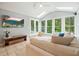 Cozy sunroom filled with natural light, tile floors, and comfortable seating, perfect for relaxation at 627 Apache Trl, Woodstock, GA 30189