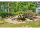 Backyard waterfall feature with surrounding shrubbery at 627 Apache Trl, Woodstock, GA 30189