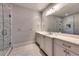 Elegant bathroom featuring white cabinets, marble floors, and a walk-in shower with glass door at 201 Dovecrest Dr, Atlanta, GA 30305