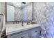 Chic powder room featuring designer wallpaper and modern fixtures at 201 Dovecrest Dr, Atlanta, GA 30305