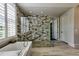 Luxurious bathroom featuring a modern shower with mosaic tile and soaking tub with shuttered windows at 201 Dovecrest Dr, Atlanta, GA 30305