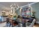Well-lit dining room showcasing a sleek table, modern light fixture, and elegant decor with a view into the kitchen at 201 Dovecrest Dr, Atlanta, GA 30305