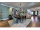 Dining room adjacent to kitchen with statement art and elegant modern lighting at 201 Dovecrest Dr, Atlanta, GA 30305