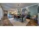 Dining room adjacent to kitchen with statement art and elegant modern lighting at 201 Dovecrest Dr, Atlanta, GA 30305