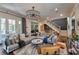Open living room with hardwood floors, neutral furniture, modern lighting, and seamless flow to the staircase at 201 Dovecrest Dr, Atlanta, GA 30305