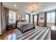Spacious main bedroom with hardwood floors, large windows, and stylish lighting at 201 Dovecrest Dr, Atlanta, GA 30305