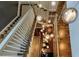 Elegant staircase with a modern lighting fixture and white railings at 201 Dovecrest Dr, Atlanta, GA 30305