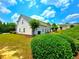 Rear view of home with a green lawn and small trees at 2077 Appaloosa Way Way, Conyers, GA 30012