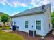 Back exterior of home featuring sliding glass doors, an air conditioning unit, and a small concrete patio area at 2077 Appaloosa Way Way, Conyers, GA 30012
