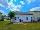 Back of house with door, window, and AC unit on a green lawn with mulch beds in a suburban setting at 2077 Appaloosa Way Way, Conyers, GA 30012