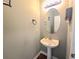 Well-lit half bathroom featuring a pedestal sink and neutral wall paint at 2077 Appaloosa Way Way, Conyers, GA 30012