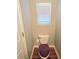 Cozy half bathroom with toilet, window with blinds, and wood-look flooring at 2077 Appaloosa Way Way, Conyers, GA 30012