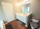 Neutral bathroom features a double sink vanity, framed mirror and wood-look flooring at 2077 Appaloosa Way Way, Conyers, GA 30012