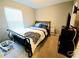 Cozy bedroom features a dark metal bedframe and a window with natural light at 2077 Appaloosa Way Way, Conyers, GA 30012