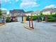 View of the gated entrance to the residential community with mature trees and landscaping at 2077 Appaloosa Way Way, Conyers, GA 30012