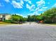 View of the gated entrance to the residential community with mature trees and landscaping at 2077 Appaloosa Way Way, Conyers, GA 30012