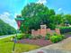 Community entrance to Spring Place Manor features brick signage with lush landscaping at 2077 Appaloosa Way Way, Conyers, GA 30012