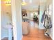 Inviting entryway with hardwood floors, coat rack, and view into the open concept kitchen and living areas at 2077 Appaloosa Way Way, Conyers, GA 30012