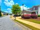 Street view of a two-story home with a two-car garage, mature trees, and well-kept landscaping at 2077 Appaloosa Way Way, Conyers, GA 30012