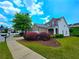 Well-maintained two-story home with a brick facade, showcasing a green lawn and colorful shrubs at 2077 Appaloosa Way Way, Conyers, GA 30012