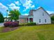 Charming two-story home with brick accents, featuring a well-maintained lawn and colorful landscaping at 2077 Appaloosa Way Way, Conyers, GA 30012