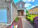 Inviting front porch features brick accents, a decorative wreath, and well-maintained landscaping at 2077 Appaloosa Way Way, Conyers, GA 30012