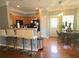 Open-concept kitchen and dining space with a breakfast bar, modern appliances, and hardwood floors at 2077 Appaloosa Way Way, Conyers, GA 30012