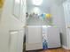 Functional laundry room featuring a washer and dryer with overhead storage at 2077 Appaloosa Way Way, Conyers, GA 30012