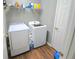 Well-lit laundry room with modern washer and dryer, plus storage shelves at 2077 Appaloosa Way Way, Conyers, GA 30012