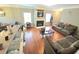 Open living space with breakfast bar, fireplace, hardwood floors, and plush seating at 2077 Appaloosa Way Way, Conyers, GA 30012