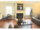 Cozy living room featuring a fireplace, hardwood floors, and comfortable seating at 2077 Appaloosa Way Way, Conyers, GA 30012