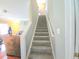 Carpeted stairway leading to the upper level of the house, with a view of the living room at 2077 Appaloosa Way Way, Conyers, GA 30012