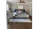 Primary bedroom with ceiling fan, hardwood floors and bedside table at 2170 Beecher Sw Cir, Atlanta, GA 30311