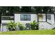 Charming home with a striking black and white exterior, highlighted by vibrant banana trees in the front yard at 2170 Beecher Sw Cir, Atlanta, GA 30311