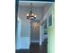 Inviting foyer featuring hardwood floors, an elegant chandelier, and a glimpse into the home's open layout at 2170 Beecher Sw Cir, Atlanta, GA 30311