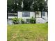 Charming two-story home boasts lush landscaping and a welcoming yellow front door at 2170 Beecher Sw Cir, Atlanta, GA 30311