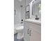 Stylish bathroom showcasing a sleek gray vanity and tub with marble surround at 458 Connally Se St, Atlanta, GA 30312