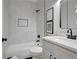 Modern bathroom featuring a tub with marble surround and sleek black hardware at 458 Connally Se St, Atlanta, GA 30312