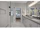 Stylish bathroom featuring a glass shower, double sinks, and elegant fixtures and lighting at 458 Connally Se St, Atlanta, GA 30312
