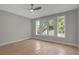Empty bedroom features hardwood floors, a ceiling fan, and large windows at 458 Connally Se St, Atlanta, GA 30312
