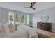 Beautiful bedroom with a large window, ceiling fan, wood floors, and neutral decor at 458 Connally Se St, Atlanta, GA 30312