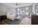 Light-filled bedroom features hardwood floors, a large window, and neutral decor at 458 Connally Se St, Atlanta, GA 30312