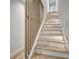 Staircase with natural wood railing and bright lighting at 458 Connally Se St, Atlanta, GA 30312