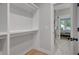 Well-organized walk-in closet with built-in shelving and easy access to the bathroom at 458 Connally Se St, Atlanta, GA 30312