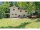 View of the back of the home with a grassy lawn and mature trees providing shade and privacy at 481 Meadowbrook Se Dr, Marietta, GA 30067
