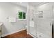 Bathroom featuring a glass walk-in shower, neutral walls and hardwood floors at 481 Meadowbrook Se Dr, Marietta, GA 30067