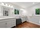 Modern bathroom featuring double sink, hardwood floors and ample sunlight at 481 Meadowbrook Se Dr, Marietta, GA 30067