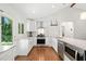 Modern kitchen with white cabinetry, stainless steel appliances and granite countertops at 481 Meadowbrook Se Dr, Marietta, GA 30067